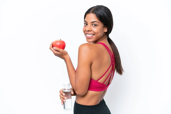 Stock image Young African american woman isolated on white background with an apple and with a bottle of water