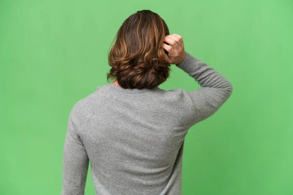 Young Caucasian Man Isolated Green Chroma Background Back Position Thinking — Stock Photo, Image