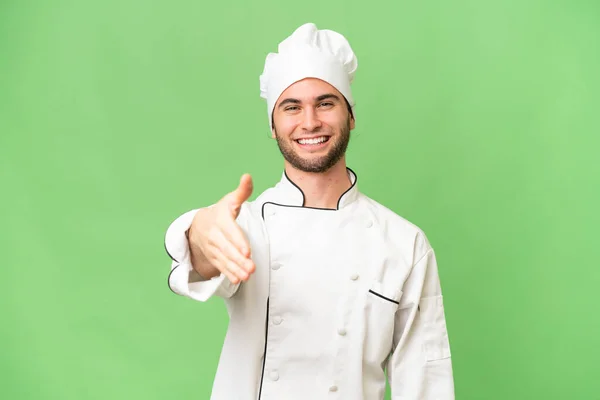 Junge Gut Aussehende Koch Mann Über Isolierten Hintergrund Schüttelt Hände — Stockfoto