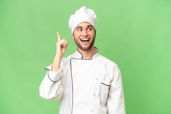 Junger Gutaussehender Koch Mit Isoliertem Hintergrund Der Die Lösung Erkennt — Stockfoto