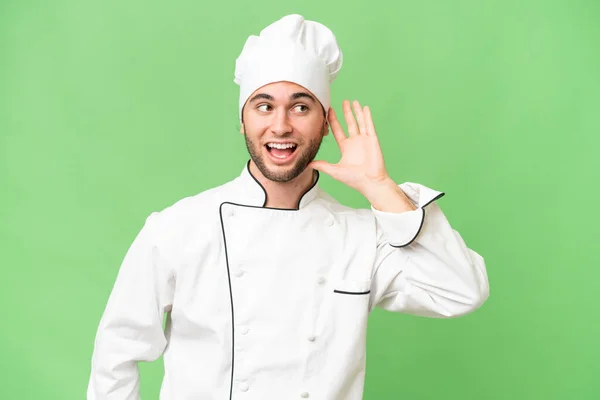 Jeune Beau Chef Homme Sur Fond Isolé Écoutant Quelque Chose — Photo