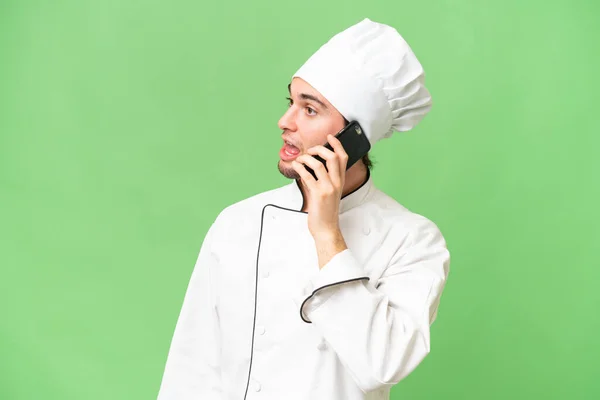 Young Handsome Chef Man Isolated Background Keeping Conversation Mobile Phone — Stock Photo, Image