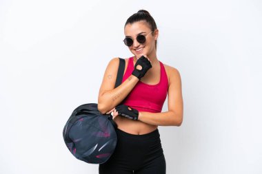 Young sport woman with sport bag isolated on white background with glasses and smiling