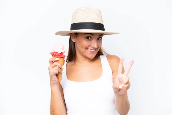 stock image Young caucasian woman with a cornet ice cream isolated on white background smiling and showing victory sign