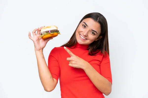 Young Caucasian Woman Holding Burger Isolated White Background Pointing — Foto de Stock