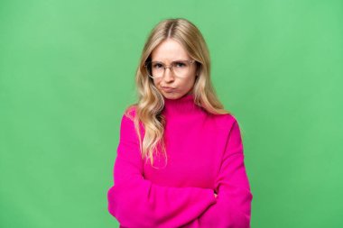 Young English woman over isolated background with unhappy expression