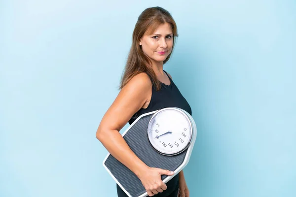Middle Aged Caucasian Woman Isolated Blue Background Weighing Machine — Stock Photo, Image