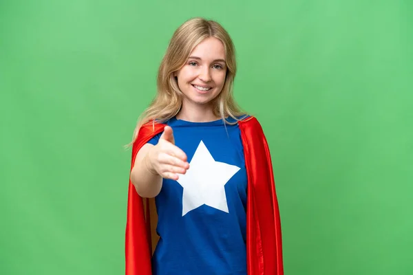 Super Hero English woman over isolated background shaking hands for closing a good deal