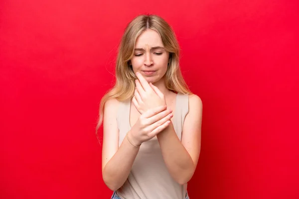 stock image Young English woman isolated on red background suffering from pain in hands