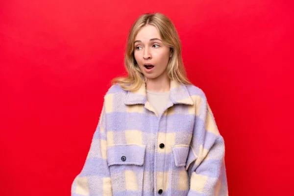 Young English Woman Isolated Red Background Doing Surprise Gesture While — стокове фото