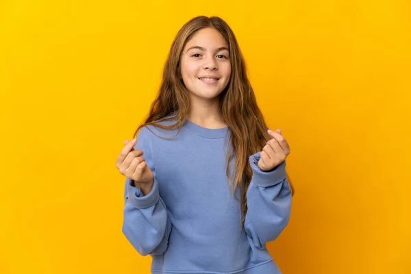 Child Isolated Yellow Background Making Money Gesture — 스톡 사진
