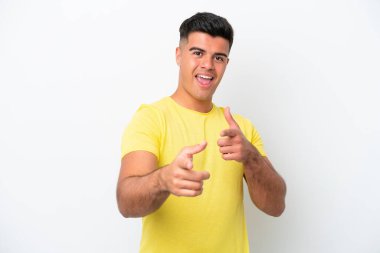 Beyaz arka planda soyutlanmış beyaz tenli yakışıklı bir adam öne bakıyor ve gülümsüyor.