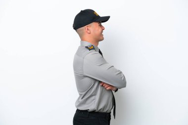 Young caucasian security man isolated on white background in lateral position