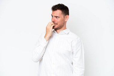 Young caucasian handsome man isolated on white background is a little bit nervous