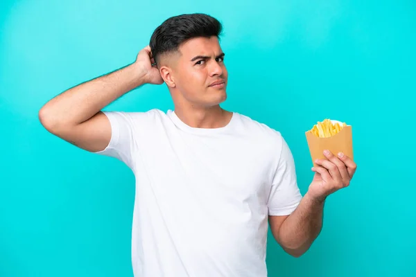 Young Caucasian Man Catching French Fries Isolated Blue Background Having — Stockfoto
