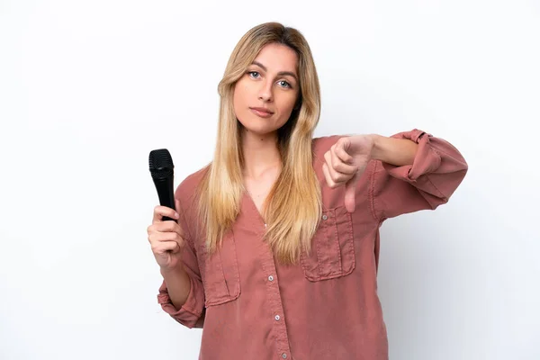 Singer Uruguayan Woman Picking Microphone Isolated White Background Showing Thumb — Stock Photo, Image