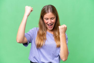 Young beautiful woman over isolated background celebrating a victory