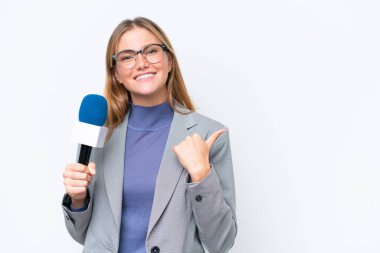 Genç TV sunucusu beyaz arka planda izole edilmiş beyaz kadın bir ürünü sunmak için kenarı işaret ediyor.