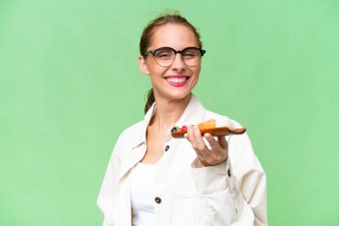 Young caucasian woman holding sashimi over isolated background with happy expression