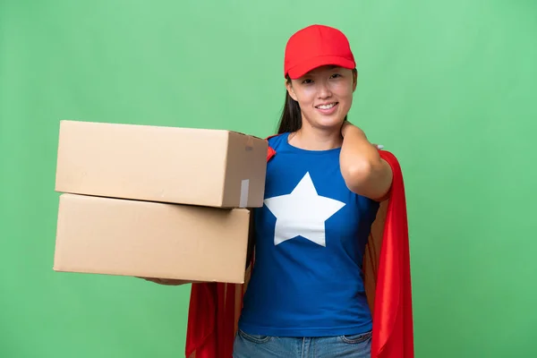 stock image Super Hero delivery Asian woman holding boxes over isolated background laughing