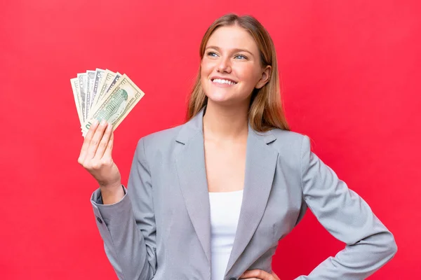 Young Business Caucasian Woman Holding Money Isolated Red Background Posing — Stock Photo, Image