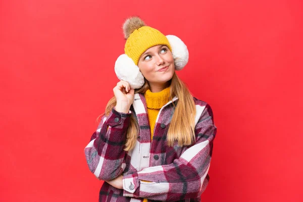 Young Beautiful Woman Wearing Winter Muffs Isolated Red Background Thinking — Stock Photo, Image