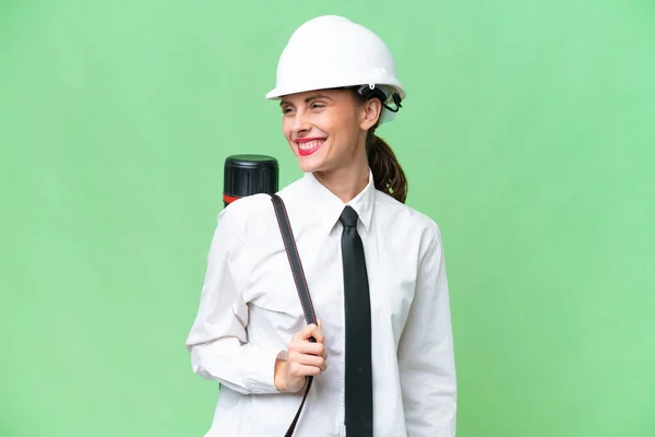 Young Architect Woman Helmet Holding Blueprints Isolated Background Looking Side — Stock Photo, Image