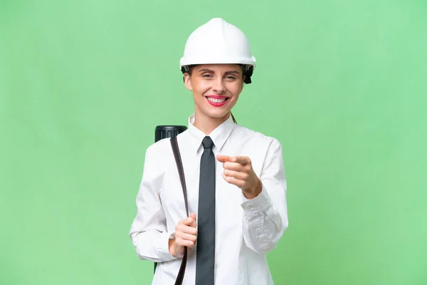 Young Architect Woman Helmet Holding Blueprints Isolated Background Surprised Pointing — Stock Photo, Image
