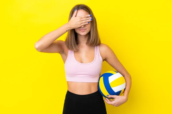黄色の背景に手で目を覆うように隔絶されたバレーボールをする若い女性 何か見たくない — ストック写真