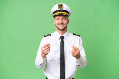 Uçak pilotu izole edilmiş arka planda para hareketi yapıyor.