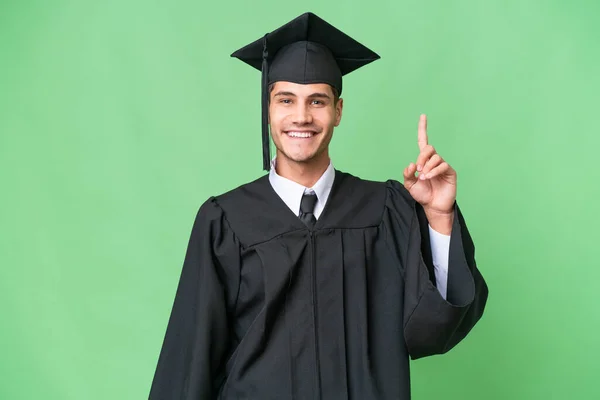 Jovem Universitário Graduado Caucasiano Homem Sobre Fundo Isolado Apontando Com — Fotografia de Stock