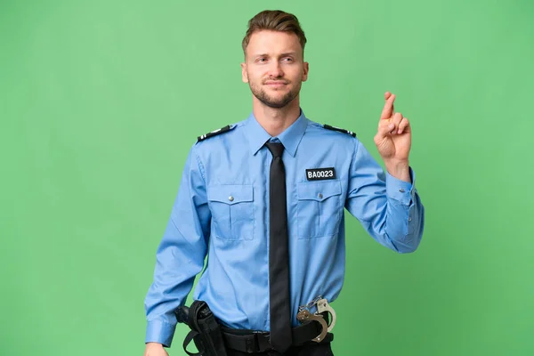 Joven Policía Sobre Fondo Aislado Con Los Dedos Cruzando Deseando —  Fotos de Stock