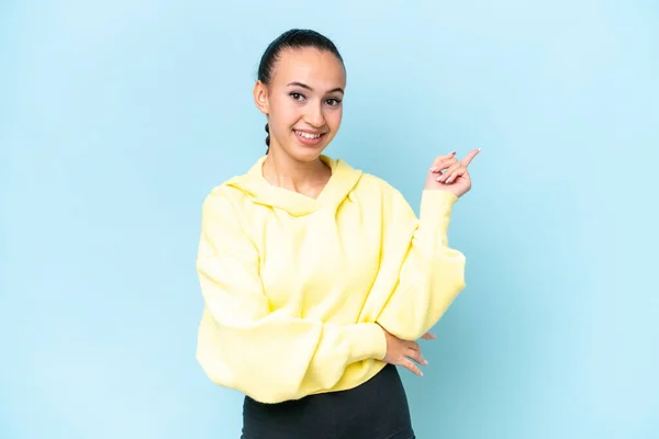 stock image Young Arab woman isolated on blue background pointing finger to the side