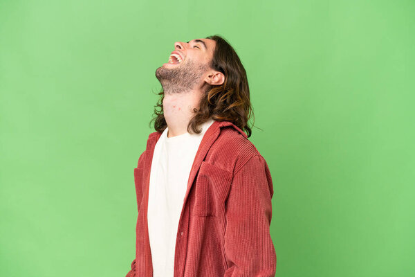 Young handsome man over isolated background laughing in lateral position