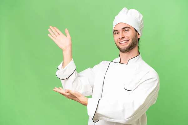 Jovem Bonito Chef Homem Sobre Isolado Fundo Estendendo Mãos Para — Fotografia de Stock