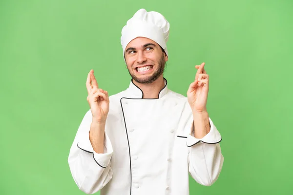 Jonge Knappe Chef Kok Man Geïsoleerde Achtergrond Met Vingers Kruisen — Stockfoto