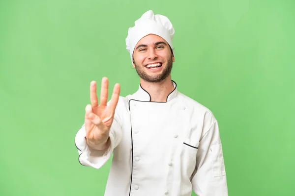 Jeune Beau Chef Homme Sur Fond Isolé Heureux Comptant Trois — Photo