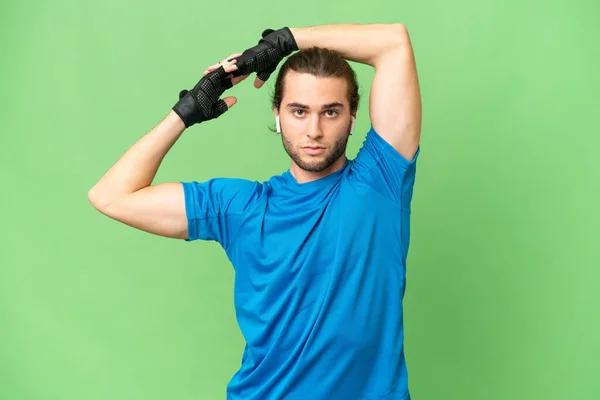 Young Handsome Man Isolated Green Chroma Background Stretching Arm — Stock Photo, Image
