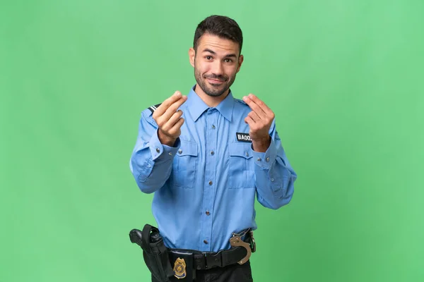 Молодий Поліцейський Білий Чоловік Над Ізольованим Фоном Заробляє Жест Грошей — стокове фото