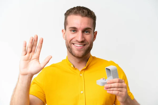 Young Man Holding Engagement Ring Isolated White Background Saluting Hand — Stock fotografie
