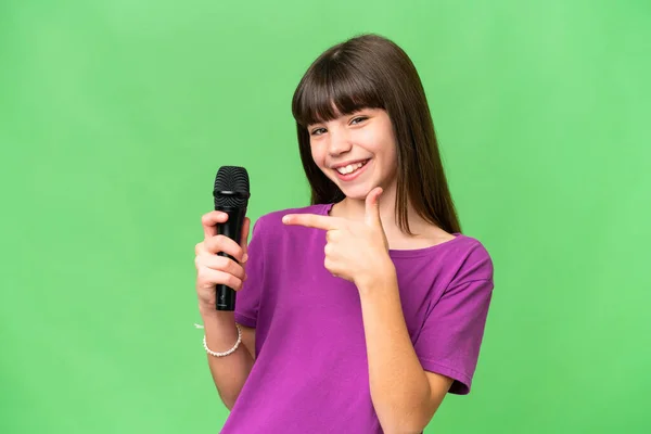 Little Singer Girl Picking Microphone Isolated Background Pointing — Stock Photo, Image