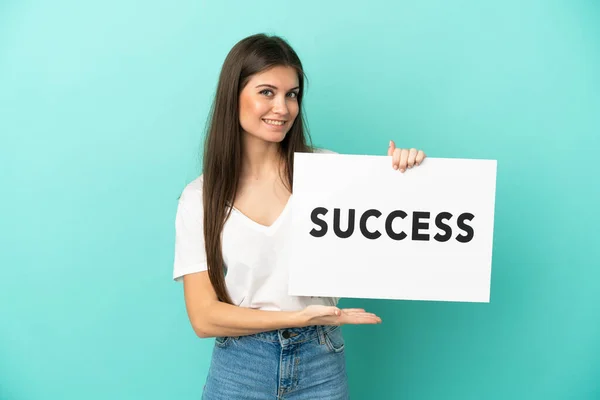 Young Caucasian Woman Isolated Blue Background Holding Placard Text Success — Stock Photo, Image