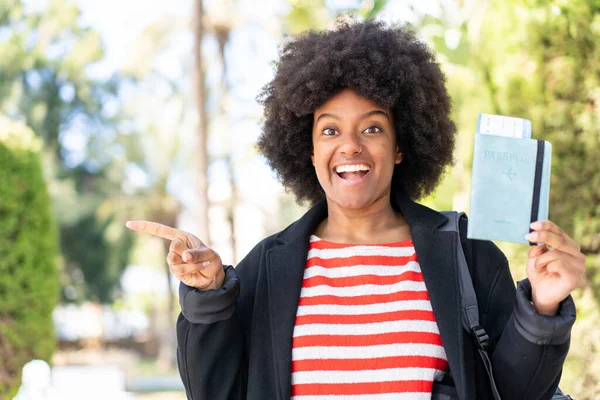 African American Girl Holding Passport Outdoors Surprised Pointing Finger Side — Stock Photo, Image