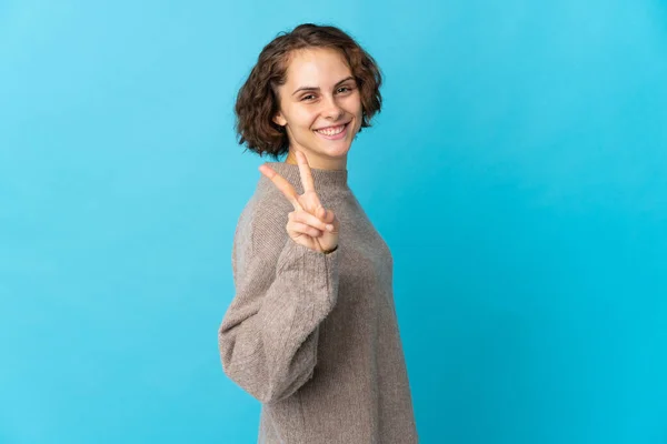 Young English Woman Isolated Blue Background Smiling Showing Victory Sign — стоковое фото