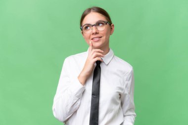 Young business caucasian woman over isolated background thinking an idea while looking up