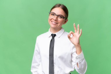 Young business caucasian woman over isolated background showing ok sign with fingers