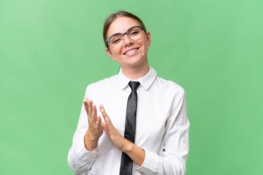 Young business caucasian woman over isolated background applauding after presentation in a conference