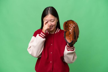 Young asian woman with baseball glove over isolated background laughing
