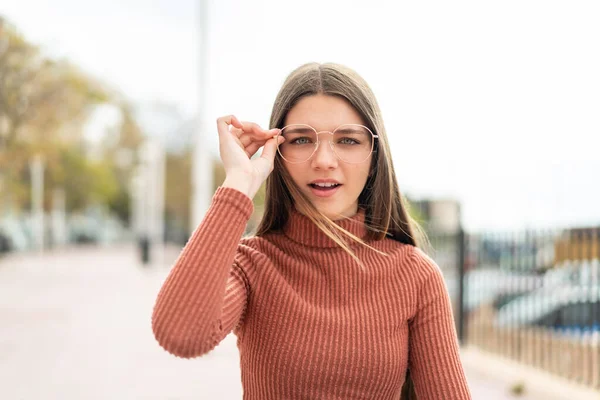 stock image Teenager girl at outdoors With glasses and frustrated expression