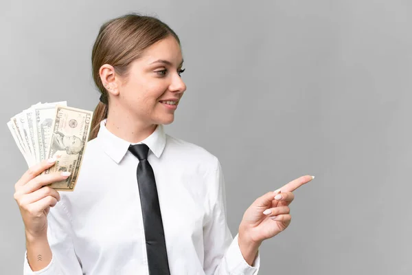 Young Business Caucasian Woman Holding Money Isolated Background Pointing Side — Foto de Stock